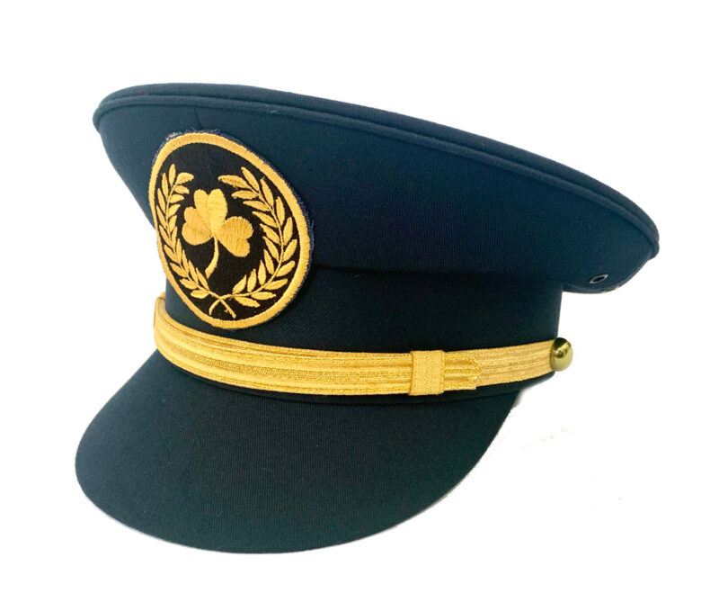 Front view of a childrens navy pilot cap with gold band and embroidered shamrock emblem