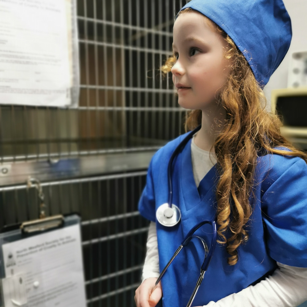 a child wearing blue medical scrubs